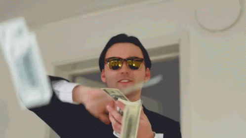Guy tossing dollar bills into the air