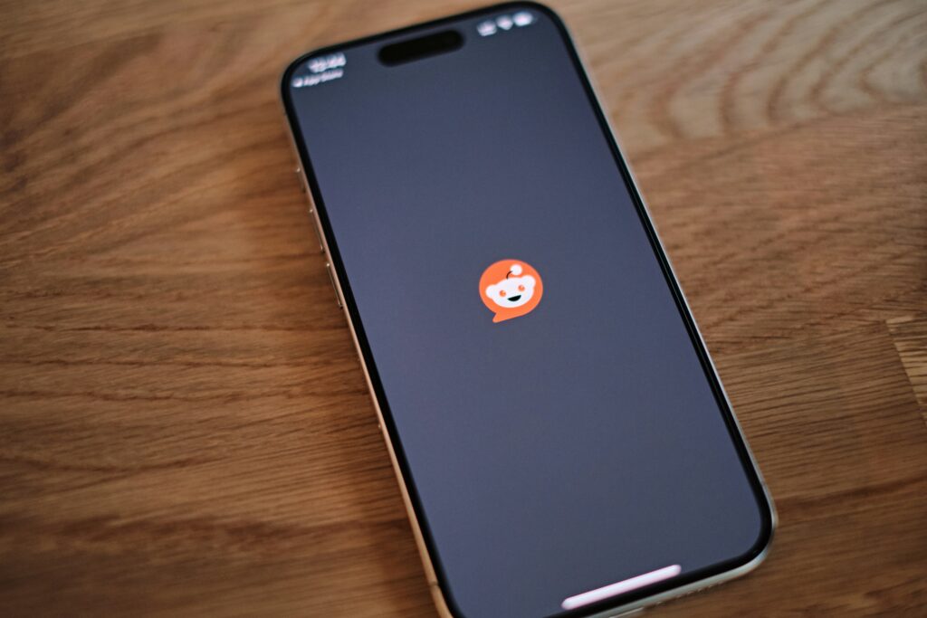 A smartphone with the Reddit app loading