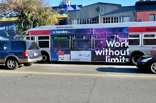 Ad on the side of a bus for monday.com
